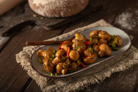 Mushroom salad with chilli, peppers and herbsの写真素材