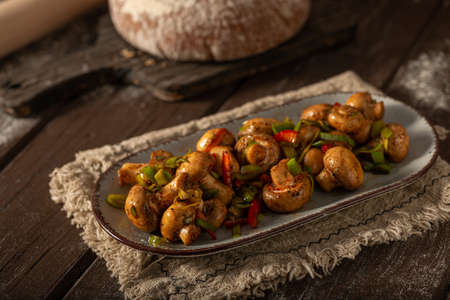 Mushroom salad with chilli, peppers and herbsの写真素材