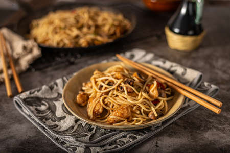 Delicious noodles with crispy chicken and mushroomsの写真素材