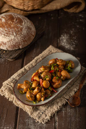 Mushroom salad with chilli, peppers and herbsの写真素材