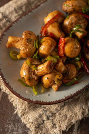 Mushroom salad with chilli, peppers and herbsの写真素材