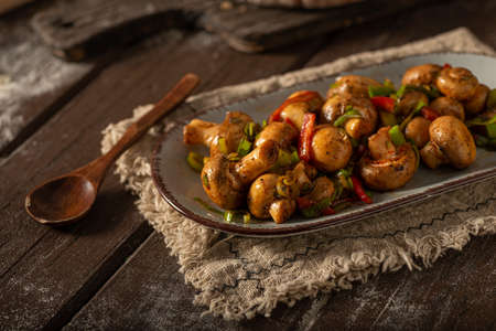 Mushroom salad with chilli, peppers and herbsの写真素材