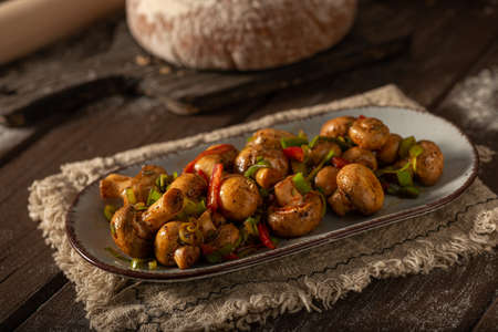 Mushroom salad with chilli, peppers and herbsの写真素材