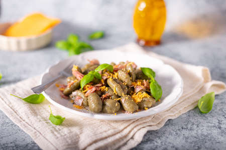 Homemade spinach gnocchi with ham and cheddar cheeseの写真素材