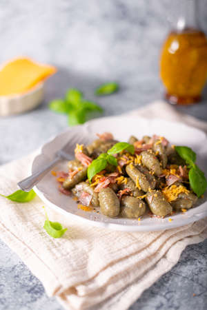 Homemade spinach gnocchi with ham and cheddar cheeseの写真素材