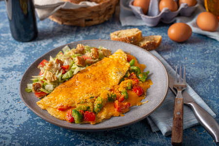 Delicious omelette from organic eggs with peppers and cheddarの写真素材