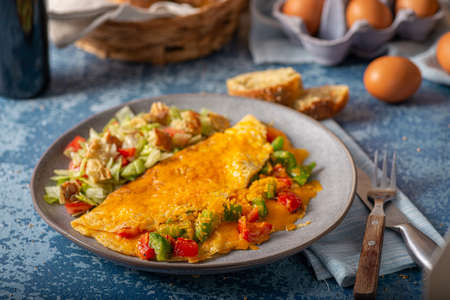 Delicious omelette from organic eggs with peppers and cheddarの写真素材
