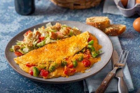 Delicious omelette from organic eggs with peppers and cheddarの写真素材