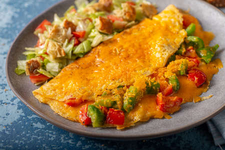 Delicious omelette from organic eggs with peppers and cheddarの写真素材