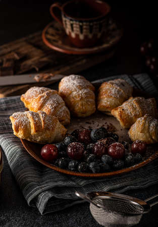 Chocolate filled pastry with berries, all homemadeの写真素材