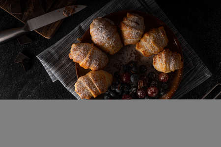 Chocolate filled pastry with berries, all homemadeの写真素材
