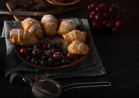 Chocolate filled pastry with berries, all homemadeの写真素材