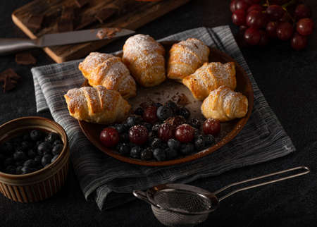 Chocolate filled pastry with berries, all homemadeの写真素材