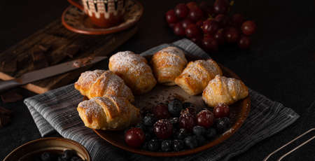 Chocolate filled pastry with berries, all homemadeの写真素材