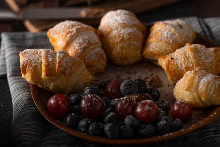 Chocolate filled pastry with berries, all homemadeの写真素材