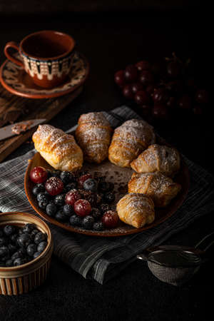Chocolate filled pastry with berries, all homemadeの写真素材