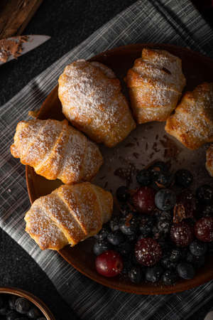 Chocolate filled pastry with berries, all homemadeの写真素材