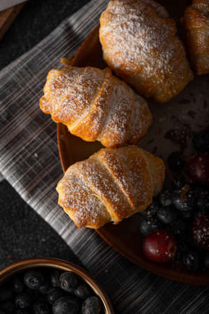 Chocolate filled pastry with berries, all homemadeの写真素材