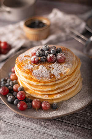 American pancakes with berries and maple syrupの写真素材