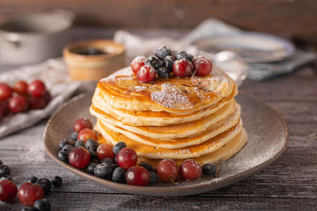 American pancakes with berries and maple syrupの写真素材