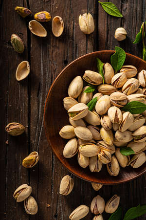 Pistachio nuts product photography on wood board