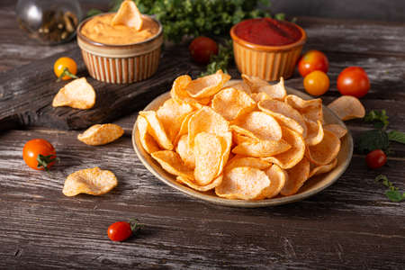Organic paprika chips with tomatoes and herbsの写真素材