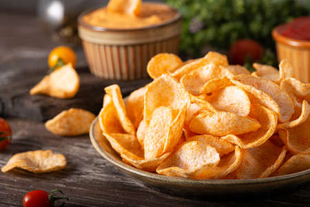 Organic paprika chips with tomatoes and herbsの写真素材