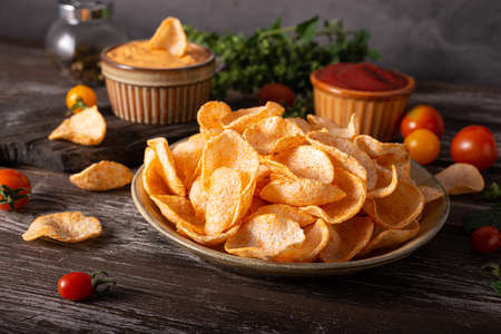 Organic paprika chips with tomatoes and herbsの写真素材