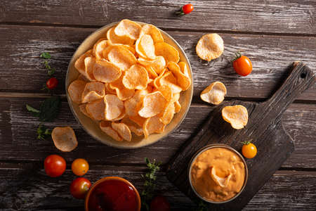 Organic paprika chips with tomatoes and herbsの写真素材