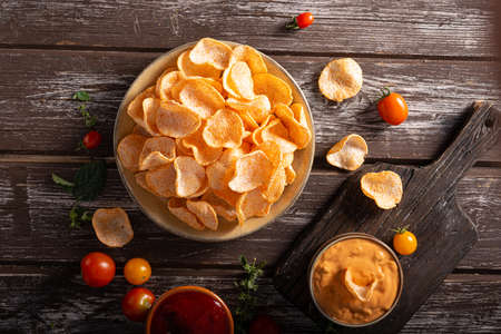 Organic paprika chips with tomatoes and herbsの写真素材