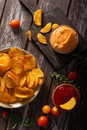 Organic paprika chips with tomatoes and herbsの写真素材