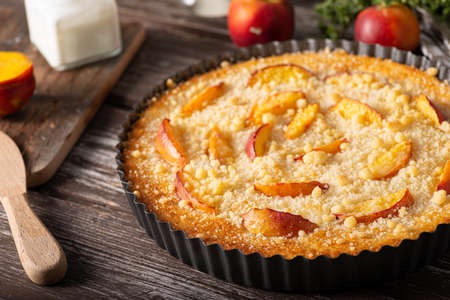 Nectarine tart with sugar and fresh mintの写真素材