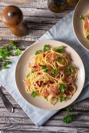Delicious pasta with garlic, ham and parmesanの写真素材