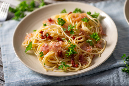 Delicious pasta with garlic, ham and parmesanの写真素材