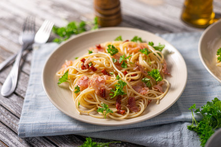 Delicious pasta with garlic, ham and parmesanの写真素材