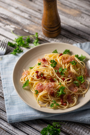 Delicious pasta with garlic, ham and parmesanの写真素材
