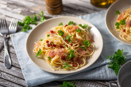 Delicious pasta with garlic, ham and parmesanの写真素材