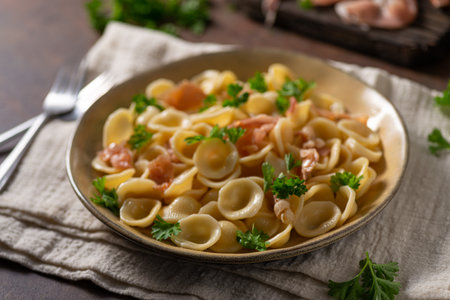 Delicious pasta with garlic, ham and parmesanの写真素材