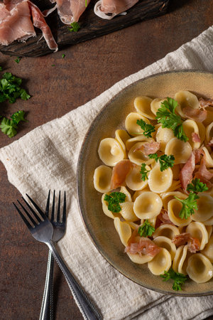 Delicious pasta with garlic, ham and parmesanの写真素材