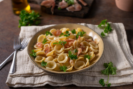 Delicious pasta with garlic, ham and parmesanの写真素材