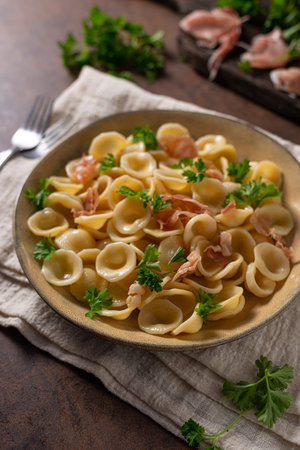 Delicious pasta with garlic, ham and parmesanの写真素材