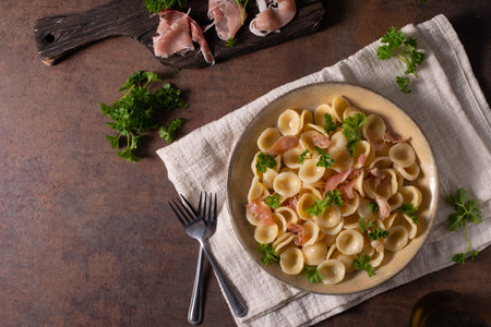 Delicious pasta with garlic, ham and parmesanの写真素材