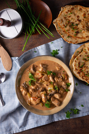Tikka masala with herbs and homemade naan breadの写真素材