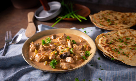 Tikka masala with herbs and homemade naan breadの写真素材