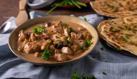 Tikka masala with herbs and homemade naan breadの写真素材