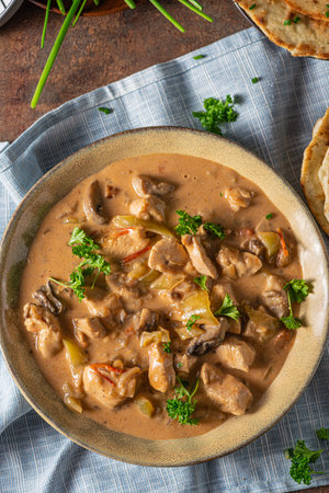 Tikka masala with herbs and homemade naan breadの写真素材