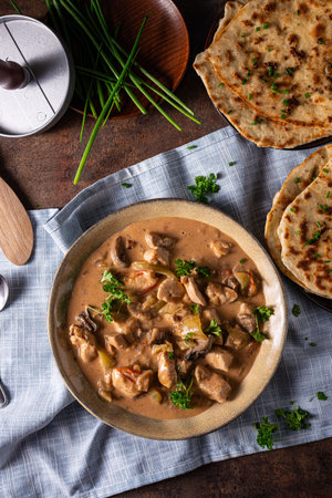 Tikka masala with herbs and homemade naan breadの写真素材
