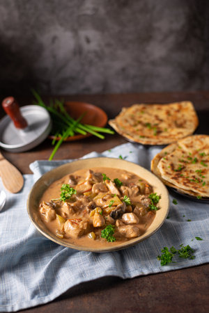Tikka masala with herbs and homemade naan breadの写真素材