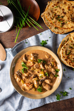 Tikka masala with herbs and homemade naan breadの写真素材