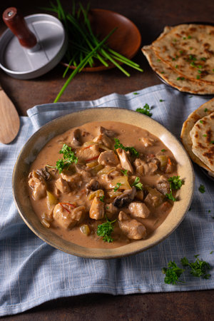 Tikka masala with herbs and homemade naan breadの写真素材